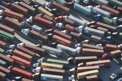 Trucks stand prepared to haul shipping containers at the Port of Los Angeles