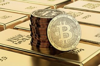 Picture of bitcoins sitting on top of a stack of gold bricks